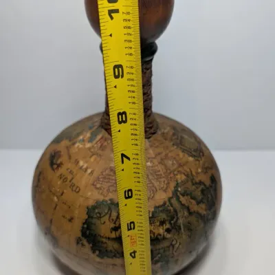 Sale Photo Thumbnail #30: Vintage 1960s leather-wrapped world map bottles are iconic mid-century barware collectibles. Most were handcrafted in Italy (particularly Florence) as decorative decanters for wine or liquor

Materials: Green or brown glass bottles encased in genuine, hea