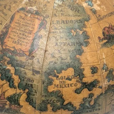Sale Photo Thumbnail #24: Vintage 1960s leather-wrapped world map bottles are iconic mid-century barware collectibles. Most were handcrafted in Italy (particularly Florence) as decorative decanters for wine or liquor

Materials: Green or brown glass bottles encased in genuine, hea