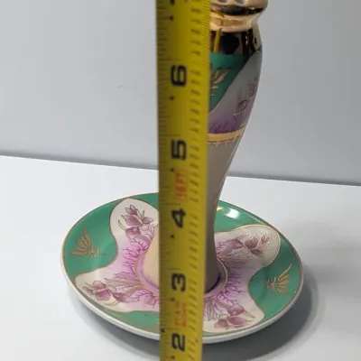 Sale Photo Thumbnail #76: The Limoges Porcelain Gold Gilded 10-Hole Hat Pin Holder is a highly collectible vintage vanity piece. Typically crafted between the late 1800s and the 1920s—the height of the Victorian and Edwardian hatpin era—these hand-painted porcelain holders fea