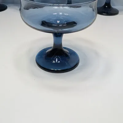 Sale Photo Thumbnail #199: These vintage 1980s Libbey Connoisseur (Dusky Blue) champagne glasses are 8-ounce, hand-blown coupes measuring roughly \(3\frac{3}{4}\text{ inches}\) tall and \(3\frac{3}{4}\text{ inches}\) wide. They are highly collectible and often used for both champag