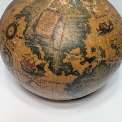 Sale Photo Thumbnail #23: Vintage 1960s leather-wrapped world map bottles are iconic mid-century barware collectibles. Most were handcrafted in Italy (particularly Florence) as decorative decanters for wine or liquor

Materials: Green or brown glass bottles encased in genuine, hea