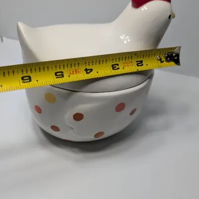 Sale Photo Thumbnail #146: The TAG (often sold as Tag Kitchen) Polka Dot Chicken Covered Nesting Candy Dishes feature a whimsical, dual-compartment design. Made of ceramic, these brightly colored lidded bowls measure roughly 5 inches long and 6.5 inches tall, making them ideal coun