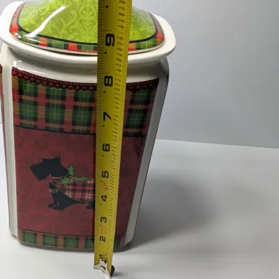 Sale Photo Thumbnail #162: The Christmas Scotty collection by 222 Fifth (PTS) is a highly sought-after holiday dinnerware line featuring a classic Scottish Terrier wearing an argyle sweater, set against a vibrant green, red, and yellow plaid backdrop. Because this specific holiday 