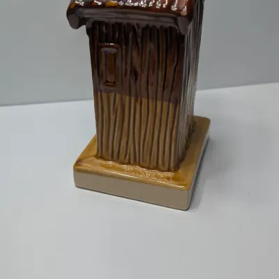 Sale Photo Thumbnail #102: The vintage "Kentucky Hillbilly Outhouse" ceramic coin bank is a popular mid-to-late 20th-century novelty travel souvenir. These campy, kitschy collectibles were mass-produced in Taiwan primarily during the 1970s and 1980s for tourist gift shops across Am