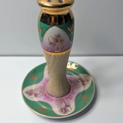 Sale Photo Thumbnail #68: The Limoges Porcelain Gold Gilded 10-Hole Hat Pin Holder is a highly collectible vintage vanity piece. Typically crafted between the late 1800s and the 1920s—the height of the Victorian and Edwardian hatpin era—these hand-painted porcelain holders fea