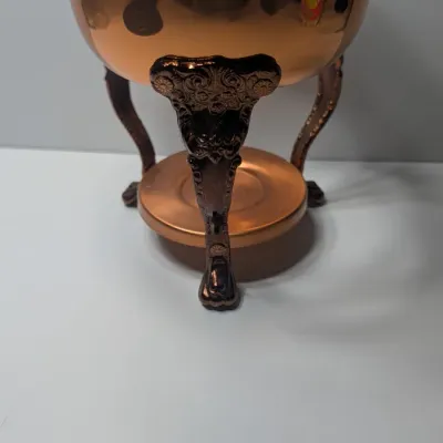 Sale Photo Thumbnail #7: The vintage Princess House copper and brass coffee carafe with stand is a popular 1960s and 1970s mid-century piece designed for elegant tabletop coffee or tea service