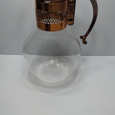 Sale Photo Thumbnail #10: The vintage Princess House copper and brass coffee carafe with stand is a popular 1960s and 1970s mid-century piece designed for elegant tabletop coffee or tea service