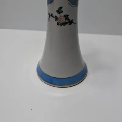 Sale Photo Thumbnail #81: This Antique Nippon Hat Pin Holder features beautifully detailed, hand-painted florals set against a light blue band and accented with elegant gold trim. Made in Japan during the late 19th or early 20th century, these delicate porcelain vanity pieces are 