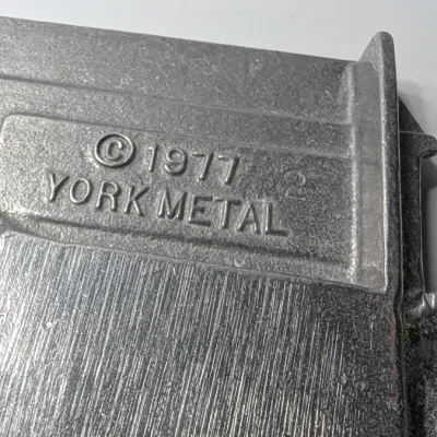 Sale Photo Thumbnail #211: The Vintage Pewter Noah's Ark Mug & Plate Set by York Metal (1977) is a classic child's dinnerware set. The divided tray measures approximately 10" x 8" shaped as the Ark, and the 3" mug often features the alphabet or Noah's Ark graphics.