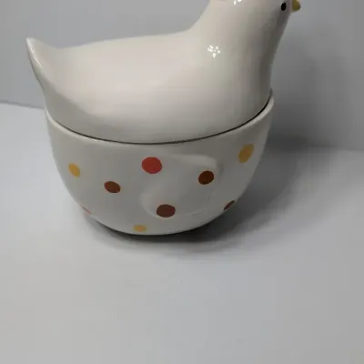 Sale Photo Thumbnail #137: The TAG (often sold as Tag Kitchen) Polka Dot Chicken Covered Nesting Candy Dishes feature a whimsical, dual-compartment design. Made of ceramic, these brightly colored lidded bowls measure roughly 5 inches long and 6.5 inches tall, making them ideal coun