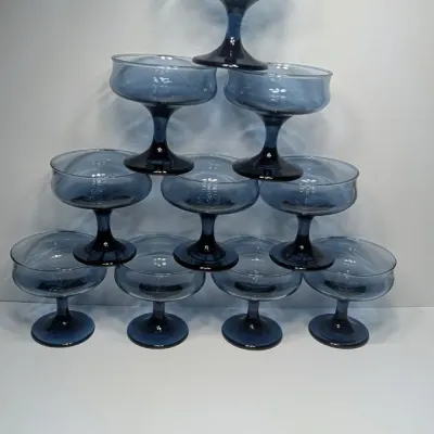 Sale Photo Thumbnail #198: These vintage 1980s Libbey Connoisseur (Dusky Blue) champagne glasses are 8-ounce, hand-blown coupes measuring roughly \(3\frac{3}{4}\text{ inches}\) tall and \(3\frac{3}{4}\text{ inches}\) wide. They are highly collectible and often used for both champag
