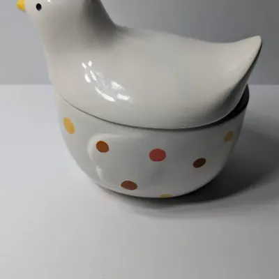 Sale Photo Thumbnail #134: The TAG (often sold as Tag Kitchen) Polka Dot Chicken Covered Nesting Candy Dishes feature a whimsical, dual-compartment design. Made of ceramic, these brightly colored lidded bowls measure roughly 5 inches long and 6.5 inches tall, making them ideal coun