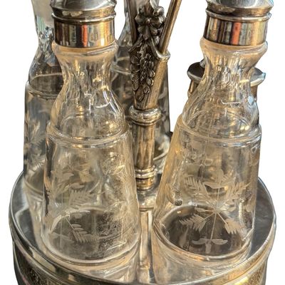 Antique Victorian Silver-Plated Condiment or Cruet Set featuring an Ornate Pedestal Stand with a Central Handle and Matching Glass Bottles