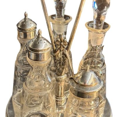 Antique Victorian Silver-Plated Condiment or Cruet Set featuring an Ornate Pedestal Stand with a Central Handle and Matching Glass Bottles