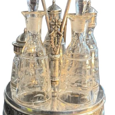 Antique Victorian Silver-Plated Condiment or Cruet Set featuring an Ornate Pedestal Stand with a Central Handle and Matching Glass Bottles