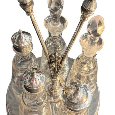 Antique Victorian Silver-Plated Condiment or Cruet Set featuring an Ornate Pedestal Stand with a Central Handle and Matching Glass Bottles