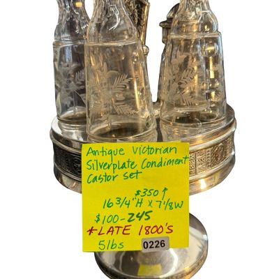 Antique Victorian Silver-Plated Condiment or Cruet Set featuring an Ornate Pedestal Stand with a Central Handle and Matching Glass Bottles
