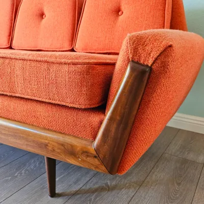 MCM Adrian Pearsall-style Gondola Sofa in Vibrant Textured Orange Fabric with Walnut Wood Accents.