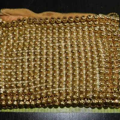 Sale Photo Thumbnail #344: Coin purse is attributed to Whiting & Davis and features a gold-tone mesh construction accented with gold beading and a secure zipper closure. The interior is lined with complimentary pink fabric. The piece measures approximately 4" H x 5" W x 1/4" D.....