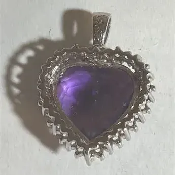 Sale Photo Thumbnail #138: Elegant Amethyst Heart Pendant .925 Sterling Silver 3.76 g
sterling marked snake chain 18" length w/ pendant
Pendant is sparkling topaz w/ ring of Rhinestones set in silver tone casing.