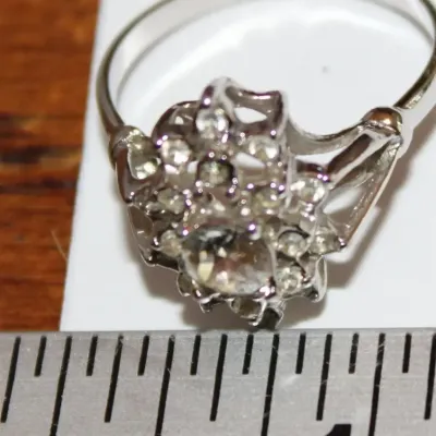 Sale Photo Thumbnail #8: This is a stunner! The photos do not do it justice. 1930s era 
Uncas International silver tone and rhinestone art deco ring. Size 8.5.

Excellent condition, marked inside with Uncas lo