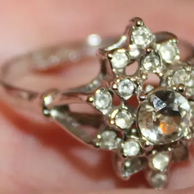 Sale Photo Thumbnail #5: This is a stunner! The photos do not do it justice. 1930s era 
Uncas International silver tone and rhinestone art deco ring. Size 8.5.

Excellent condition, marked inside with Uncas lo