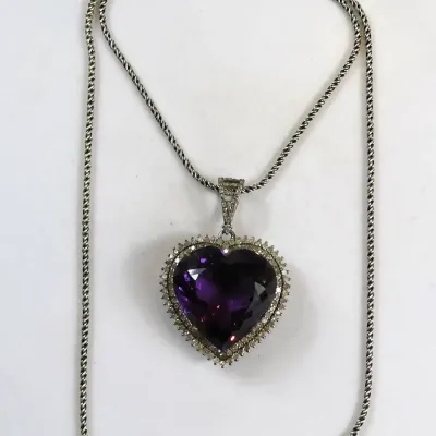 Sale Photo Thumbnail #135: Elegant Amethyst Heart Pendant .925 Sterling Silver 3.76 g
sterling marked snake chain 18" length w/ pendant
Pendant is sparkling topaz w/ ring of Rhinestones set in silver tone casing.