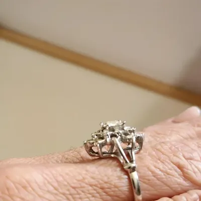 Sale Photo Thumbnail #7: This is a stunner! The photos do not do it justice. 1930s era 
Uncas International silver tone and rhinestone art deco ring. Size 8.5.

Excellent condition, marked inside with Uncas lo