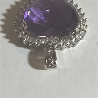 Sale Photo Thumbnail #137: Elegant Amethyst Heart Pendant .925 Sterling Silver 3.76 g
sterling marked snake chain 18" length w/ pendant
Pendant is sparkling topaz w/ ring of Rhinestones set in silver tone casing.