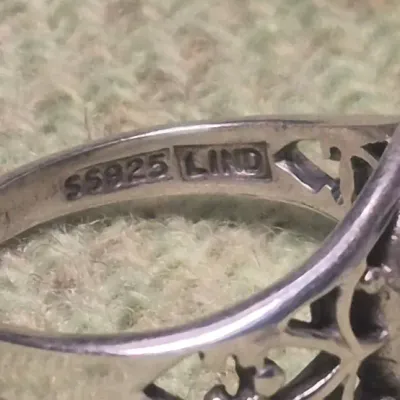 Sale Photo Thumbnail #123: Signed Sterling Ring Sz 7.~ 2.7g
Signed 'LIND' Thailand Sterling Ring Sz 7.~ 2.7g