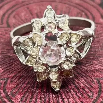 Sale Photo Thumbnail #3: This is a stunner! The photos do not do it justice. 1930s era 
Uncas International silver tone and rhinestone art deco ring. Size 8.5.

Excellent condition, marked inside with Uncas lo