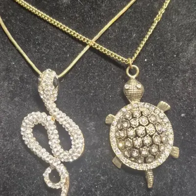 Sale Photo Thumbnail #208: Stunning Animal Pendant Necklaces ~ Turtle & Snake Rhinestone galore !
turtle is 2" on a 16" chain
snake is 4" on a 16" chain
all stones accounted for and original