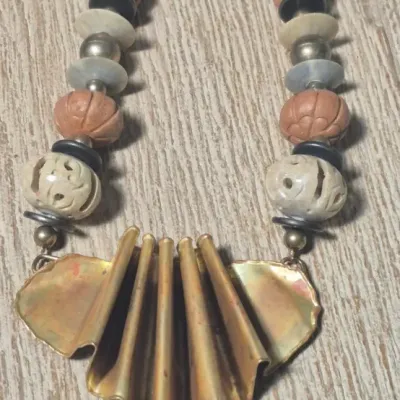 Sale Photo Thumbnail #360: Tribal Bohemian artisans Necklace with copper pleated fan



Bold statement, easy to wear not overpowering heavy



Pleated fan is the center point......16" overall