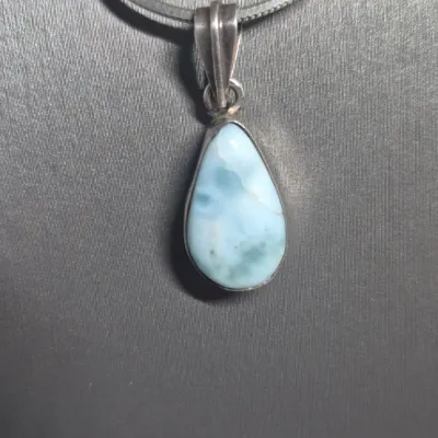 Sale Photo Thumbnail #336: Vintage LARIMAR Pendant w/ Italy 925 snake chain & Native American Feather Earrings
> Larimar in a silver bezel, found Exclusively in Dominican Republic, is a rare blue / white marbling
> snake chain marked Italy & 925.....toned to luster
> earrings are c