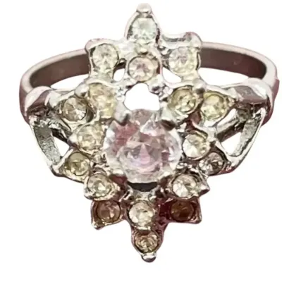 Sale Photo Thumbnail #4: This is a stunner! The photos do not do it justice. 1930s era 
Uncas International silver tone and rhinestone art deco ring. Size 8.5.

Excellent condition, marked inside with Uncas lo