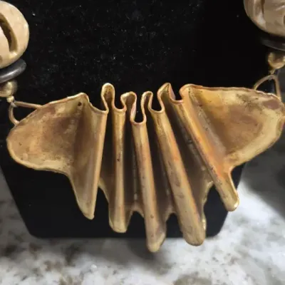 Sale Photo Thumbnail #359: Tribal Bohemian artisans Necklace with copper pleated fan



Bold statement, easy to wear not overpowering heavy



Pleated fan is the center point......16" overall