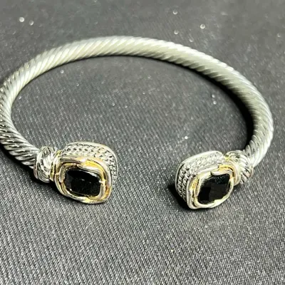 Sale Photo Thumbnail #149: Brighton pair of silver tone Bracelets ~ Juvelle & Onyx , [ pair ]
2 tone, gold plated ring around Onyx stones 7"dia, test sterling

STERLING TWO TONE LAB MADE QUARTZ HINGED 7" BANGLE 10MM BRACELET 32.3GR