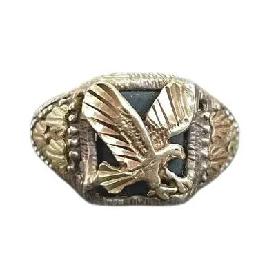 Sale Photo Thumbnail #53: Black Hills Gold Eagle Ring, Sterling SilverA men's pinky ring featuring a gold appliqued eagle on the black onyx center, as well as gold leaves on the sides. The ring itself is sterling silver and marked 925. Size 6 3/4
Weight: 4.7 grams
Beautiful men's 
