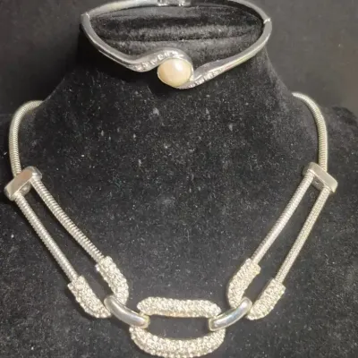 Sale Photo Thumbnail #184: Sabo Chain link Necklace w/ Pearl stud bracelet
Necklace is paper clip links that are frosted rhinestone  finish.
Bracelet is a single pearl set in solid hinged cuff....7.25