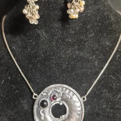 Sale Photo Thumbnail #294: Modernist hammered disc with floral accents 925 & Earrings to set marked 925
necklace is 16" length, marked 
Earrings marked short dangles cluster ....pierced