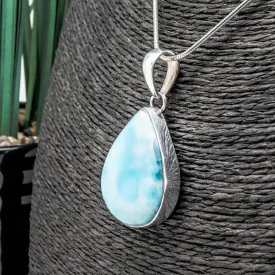 Sale Photo Thumbnail #335: Vintage LARIMAR Pendant w/ Italy 925 snake chain & Native American Feather Earrings
> Larimar in a silver bezel, found Exclusively in Dominican Republic, is a rare blue / white marbling
> snake chain marked Italy & 925.....toned to luster
> earrings are c