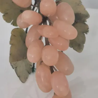 Sale Photo Thumbnail #290: This is a realistically carved rose jade bunch of grapes with darker jade carved leaves. The stem network is wire wrapped with blue satin cord and the end where it would have been cut from the vine is faux wood. The leaves and grapes have some flexibility