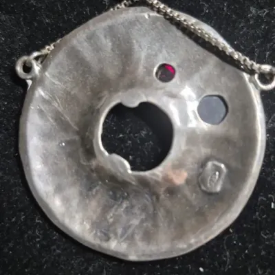 Sale Photo Thumbnail #296: Modernist hammered disc with floral accents 925 & Earrings to set marked 925
necklace is 16" length, marked 
Earrings marked short dangles cluster ....pierced