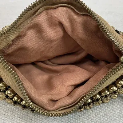 Sale Photo Thumbnail #343: Coin purse is attributed to Whiting & Davis and features a gold-tone mesh construction accented with gold beading and a secure zipper closure. The interior is lined with complimentary pink fabric. The piece measures approximately 4" H x 5" W x 1/4" D.....