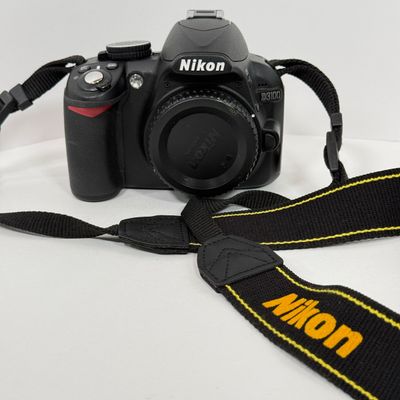 LOT 69A: Nikon D3100 Camera Body w/ Mod Camera Strap (NO BATTERY)