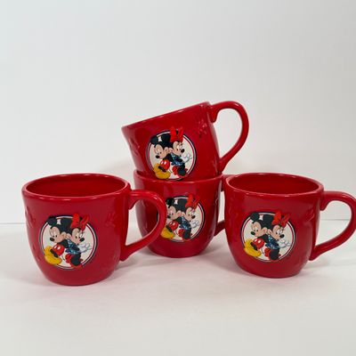 LOT 75A: Disney Mickey & Minnie Mouse Red Mugs (4) & Stainless Steel Mickey Cutout Flatware: 11 Butter Knives, 12 Tablespoons...