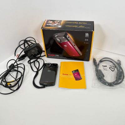 LOT 71A: Kodak Zi8 Pocket Video Camera w Box, Manuals, Charger & Cords