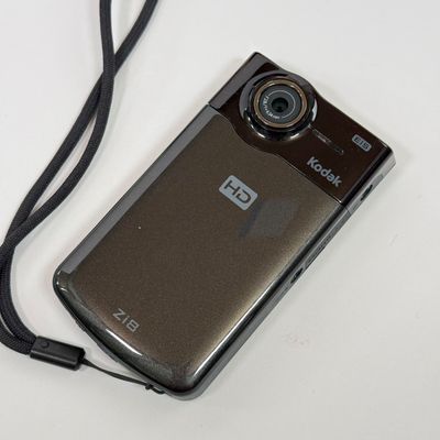 LOT 71A: Kodak Zi8 Pocket Video Camera w Box, Manuals, Charger & Cords