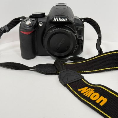 LOT 69A: Nikon D3100 Camera Body w/ Mod Camera Strap (NO BATTERY)