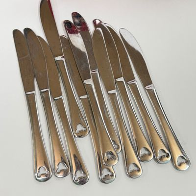 LOT 75A: Disney Mickey & Minnie Mouse Red Mugs (4) & Stainless Steel Mickey Cutout Flatware: 11 Butter Knives, 12 Tablespoons...